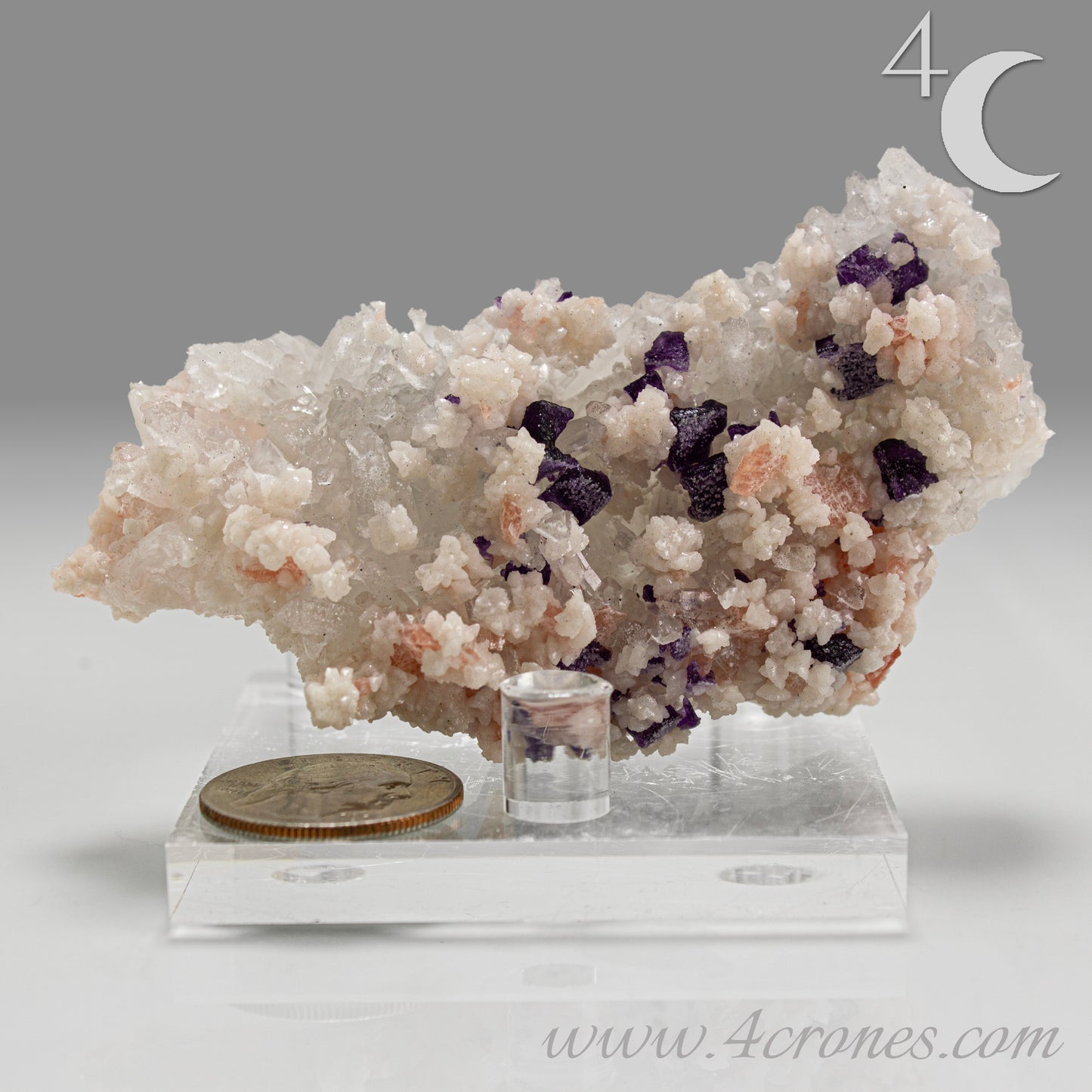 This complex and texturally rich specimen features a matrix of clear Quartz crystals scattered with pastel Rhodochrosite, sharp Purple Fluorite cubes, and creamy Dolomite crystals.