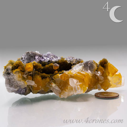 Iridescent Columnar Calcite is a striking variety of calcite distinguished by its naturally occurring columnar structure and shimmering, pearlescent sheen. This calcium carbonate mineral forms in elongated, parallel crystal columns, often displaying a soft, ethereal glow due to light interference within its layers. Its iridescence results from microscopic structural variations that reflect and refract light, producing subtle flashes of color that shift with movement. 