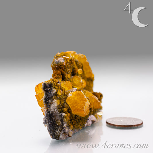 Iridescent Columnar Calcite is a striking variety of calcite distinguished by its naturally occurring columnar structure and shimmering, pearlescent sheen. This calcium carbonate mineral forms in elongated, parallel crystal columns, often displaying a soft, ethereal glow due to light interference within its layers. Its iridescence results from microscopic structural variations that reflect and refract light, producing subtle flashes of color that shift with movement. 