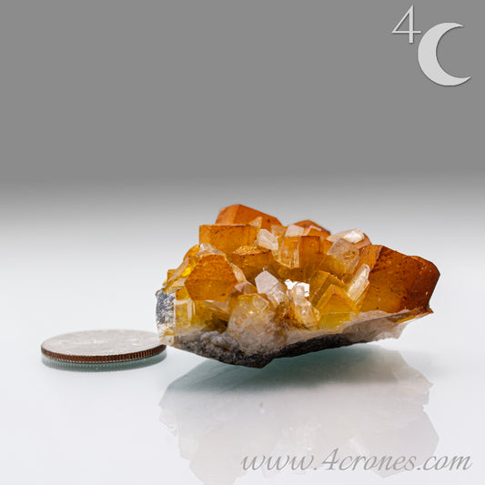 Iridescent Columnar Calcite is a striking variety of calcite distinguished by its naturally occurring columnar structure and shimmering, pearlescent sheen. This calcium carbonate mineral forms in elongated, parallel crystal columns, often displaying a soft, ethereal glow due to light interference within its layers. Its iridescence results from microscopic structural variations that reflect and refract light, producing subtle flashes of color that shift with movement. 