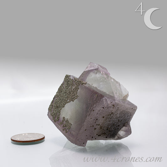 Fluorite & Pyrite beautiful lavender and soft green. This unique specimen of fluorite shimmers in soft bands of lavender and green, a natural harmony of color and energy. Composed of calcium fluoride, fluorite is valued for its cubic crystal formation and its ability to bring mental clarity and energetic alignment.