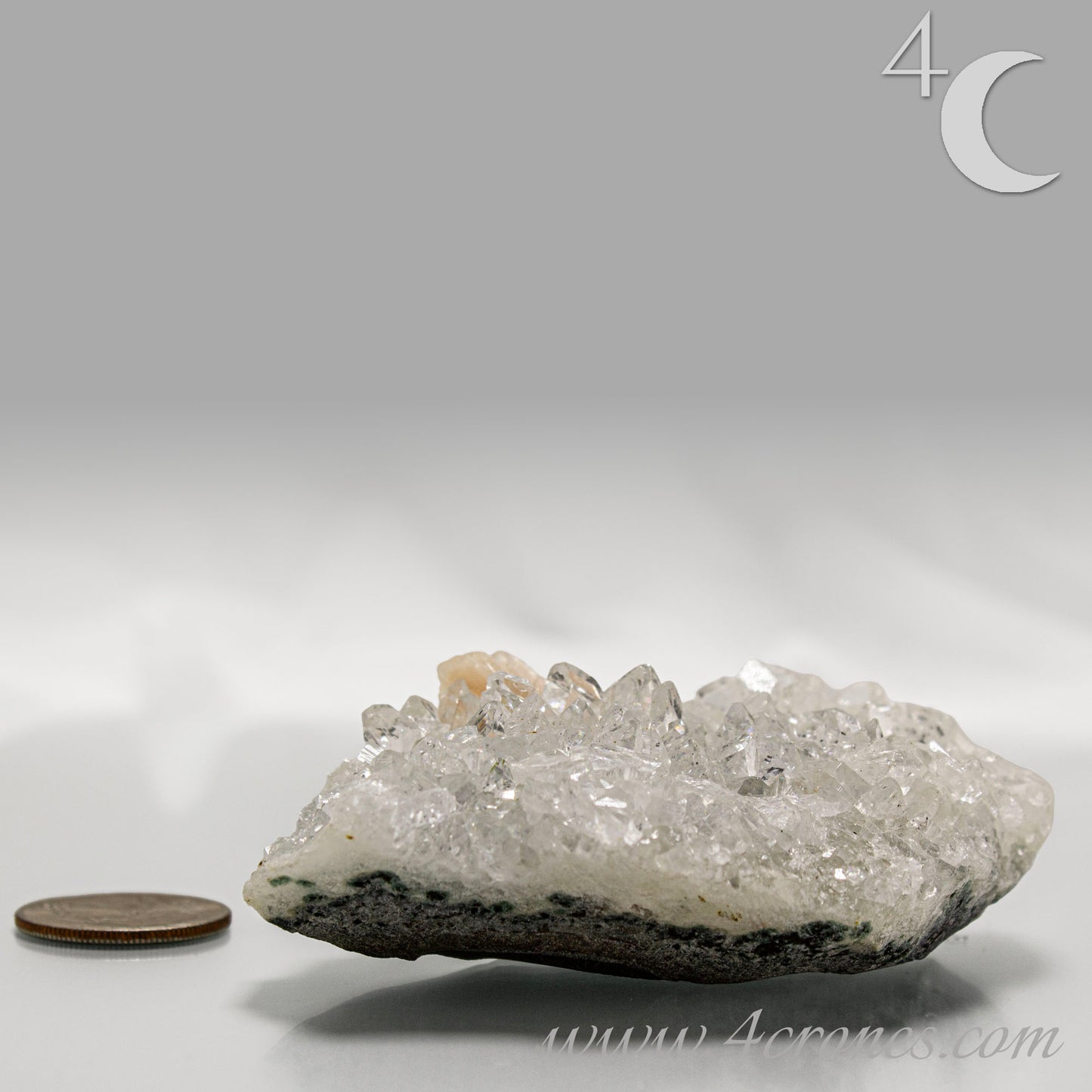 Clear apophyllite crystals intergrown with peach stilbite, natural zeolite mineral specimen from India.