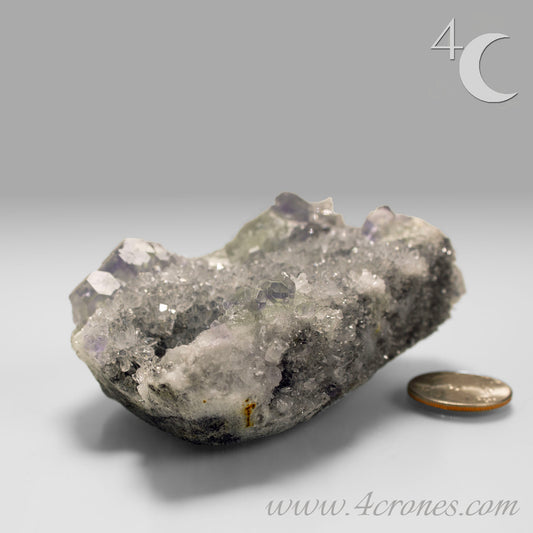 These beautiful green fluorites have enchanting delicate blue-purple phantoms. They are nestled in a dazzling bed of sparkling needle quartz and their subtlety and color shifts under various light sources create the feeling of being on a treasure hunt. Suddenly, another purple-blue phantom fluorite crystal appears amidst the crystal-clear twinkling needle quartz points. To top it off these amazing specimens glow and fluoresce a deep Lavendar under UV light. www.4crones.com