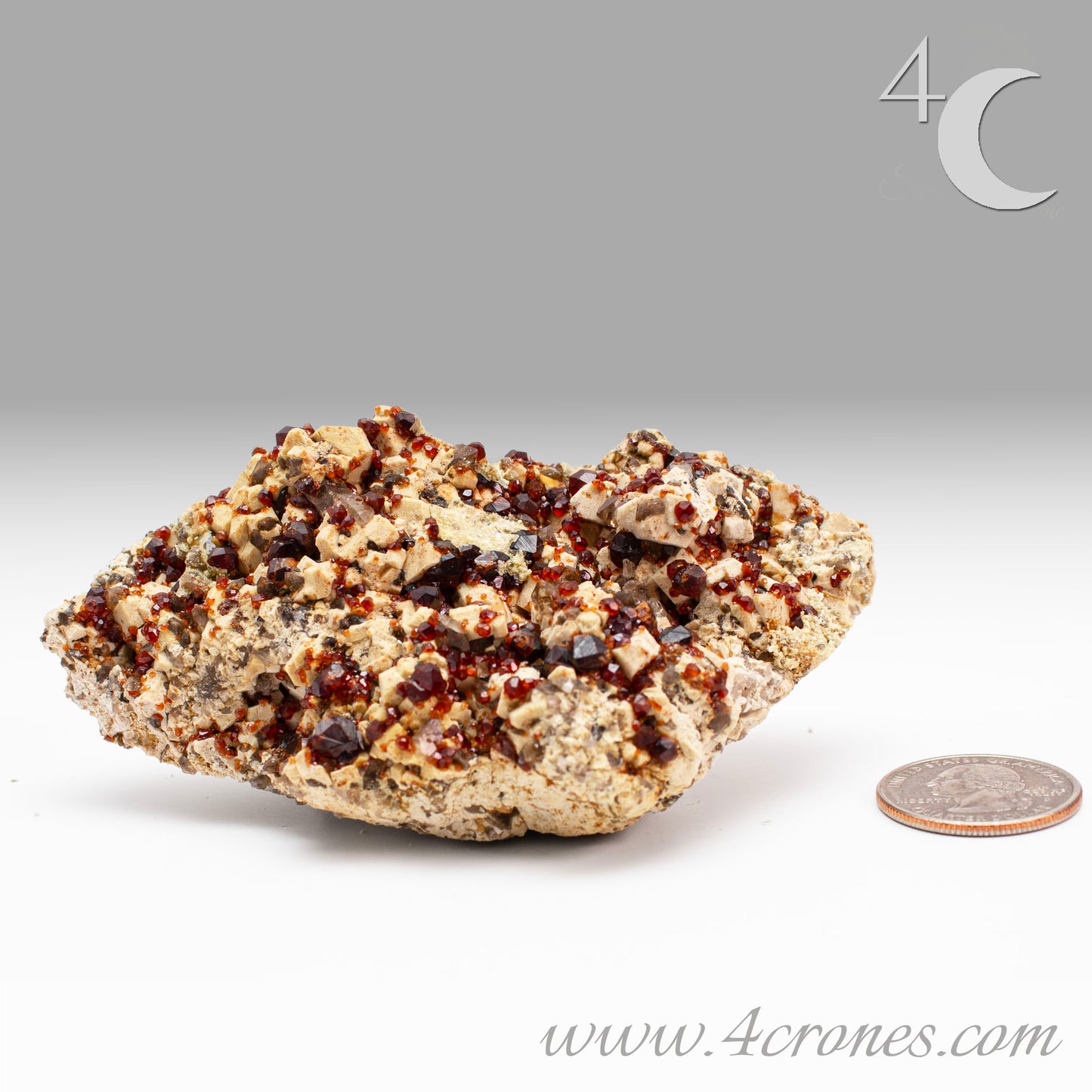 These gemmy Garnets are known as Spessartine Red Garnets, and they encrust and surround beautiful Smoky Quartz crystals on microcline feldspar matrices. The mine these specimens come from is known for the beautiful blingy red- and orange-colored garnets that they yield. www.4crones.com