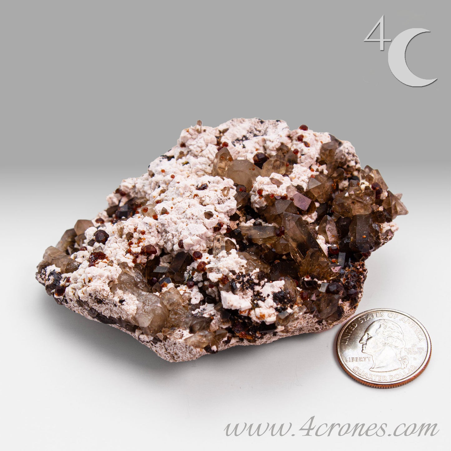 These gemmy Garnets are known as Spessartine Red Garnets, and they encrust and surround beautiful Smoky Quartz crystals on microcline feldspar matrices. The mine these specimens come from is known for the beautiful blingy red- and orange-colored garnets that they yield. www.4crones.com