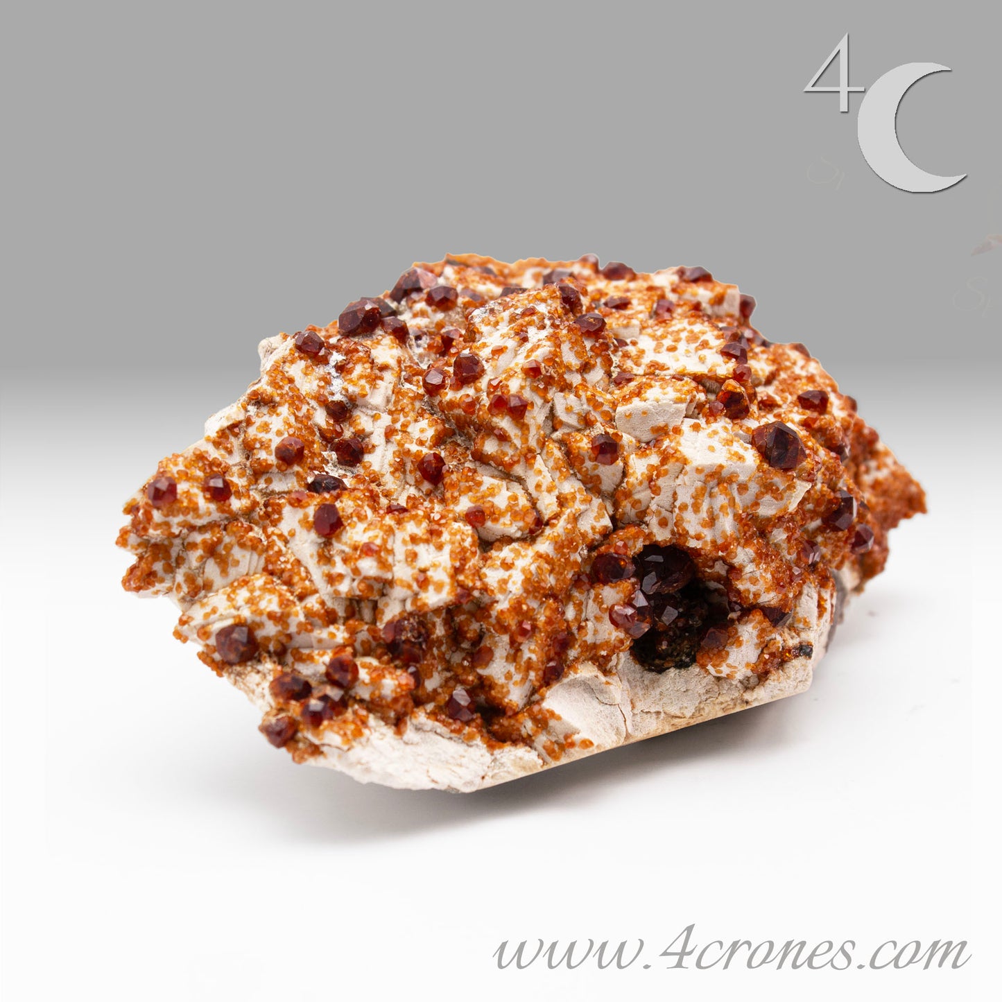 These gemmy Garnets are known as Spessartine Red Garnets, and they encrust and surround beautiful Smoky Quartz crystals on microcline feldspar matrices. The mine these specimens come from is known for the beautiful blingy red- and orange-colored garnets that they yield. www.4crones.com