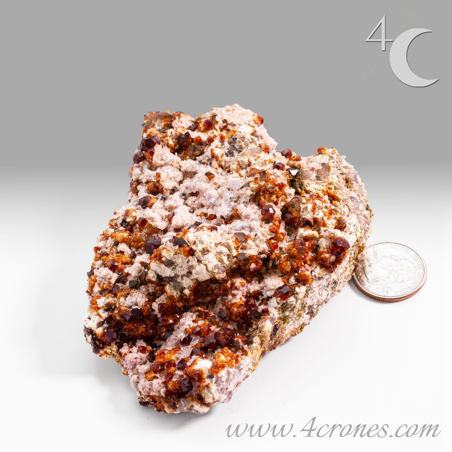 These gemmy Garnets are known as Spessartine Red Garnets, and they encrust and surround beautiful Smoky Quartz crystals on microcline feldspar matrices. The mine these specimens come from is known for the beautiful blingy red- and orange-colored garnets that they yield. www.4crones.com