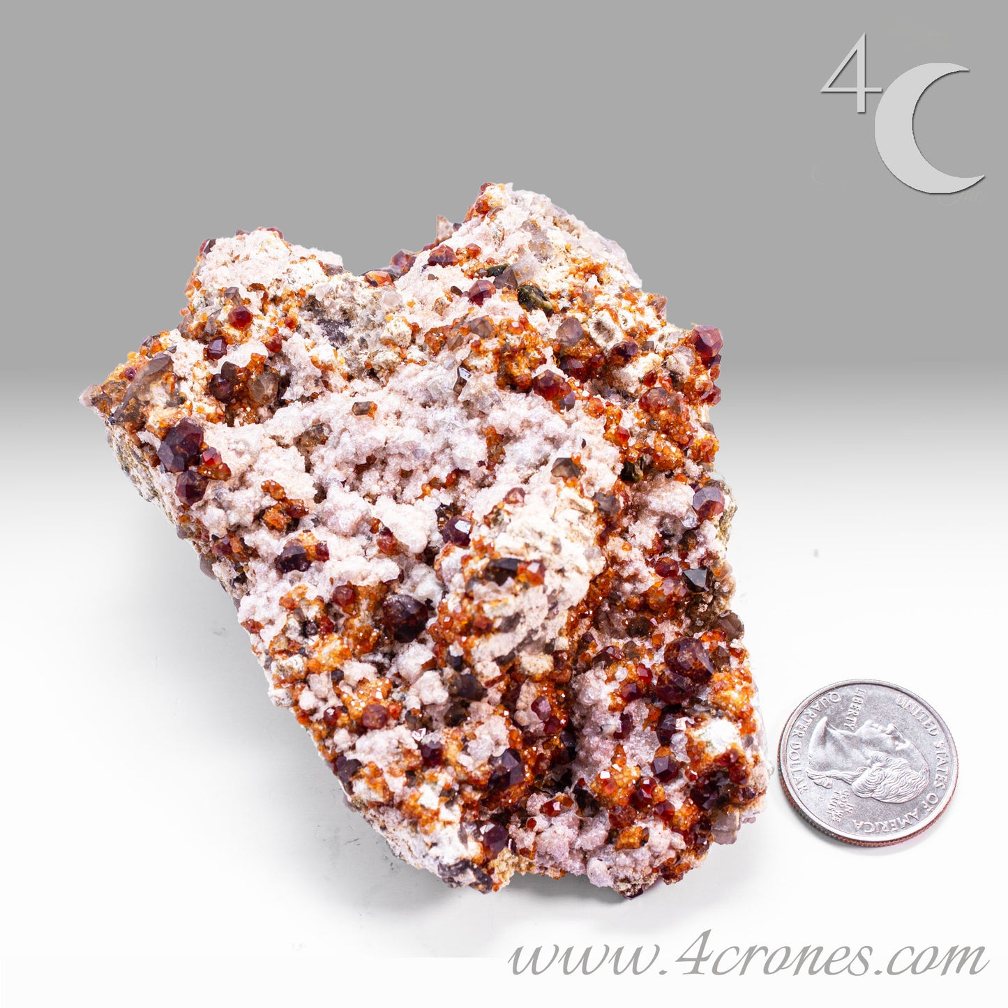 These gemmy Garnets are known as Spessartine Red Garnets, and they encrust and surround beautiful Smoky Quartz crystals on microcline feldspar matrices. The mine these specimens come from is known for the beautiful blingy red- and orange-colored garnets that they yield. www.4crones.com