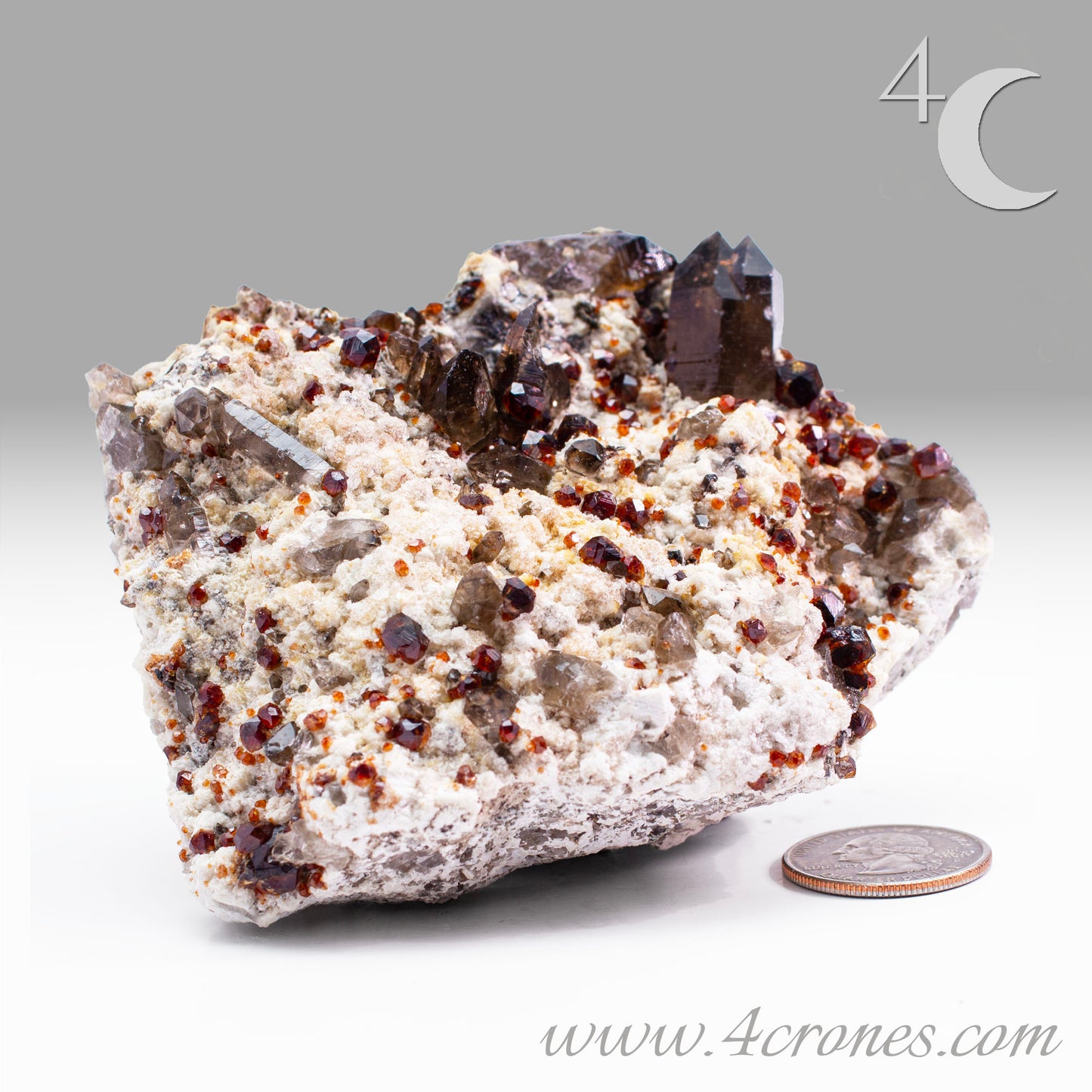 These gemmy Garnets are known as Spessartine Red Garnets, and they encrust and surround beautiful Smoky Quartz crystals on microcline feldspar matrices. The mine these specimens come from is known for the beautiful blingy red- and orange-colored garnets that they yield. www.4crones.com