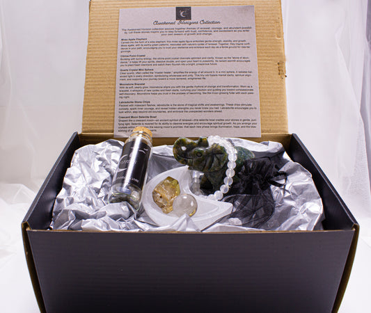 Decorative elephant figurine with beads, crystal ball, and bottle labeled '4 Crones' on a white surface.