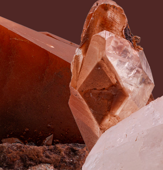 Red Diamond Calcite, glassy, gemmy diamond shaped geometries otherwise known as rhombohedrons and or scalenohedrons are combined with hematite, giving them a rusty-red coating on portions of these spectacular specimens.