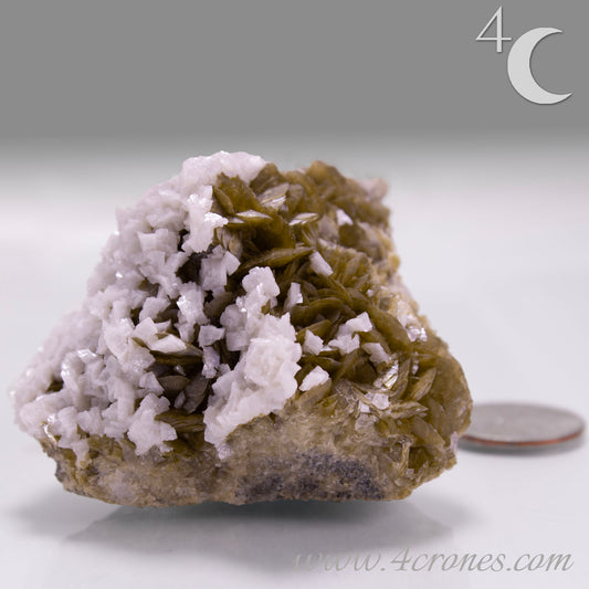 This unique pairing of Siderite, an iron carbonate mineral, and Dolomite, a calcium magnesium carbonate, forms in earthy clusters and blocky crystals that range from honeyed brown to soft cream.