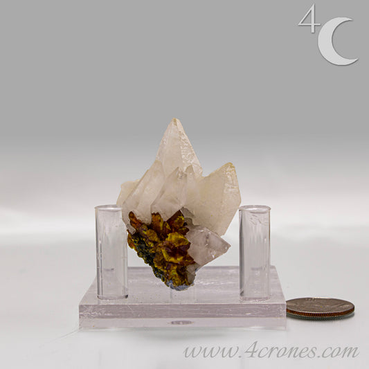 Orpiment mineral with layered golden formation on light matrix, side view