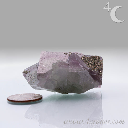 Fluorite & Pyrite beautiful lavender and soft green. This unique specimen of fluorite shimmers in soft bands of lavender and green, a natural harmony of color and energy. Composed of calcium fluoride, fluorite is valued for its cubic crystal formation and its ability to bring mental clarity and energetic alignment.