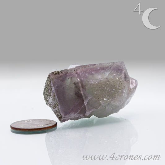 Fluorite & Pyrite beautiful lavender and soft green. This unique specimen of fluorite shimmers in soft bands of lavender and green, a natural harmony of color and energy. Composed of calcium fluoride, fluorite is valued for its cubic crystal formation and its ability to bring mental clarity and energetic alignment.