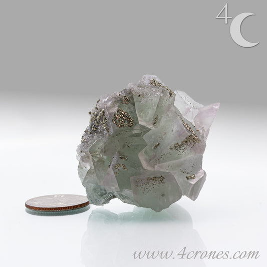 Fluorite & Pyrite beautiful lavender and soft green. This unique specimen of fluorite shimmers in soft bands of lavender and green, a natural harmony of color and energy. Composed of calcium fluoride, fluorite is valued for its cubic crystal formation and its ability to bring mental clarity and energetic alignment.