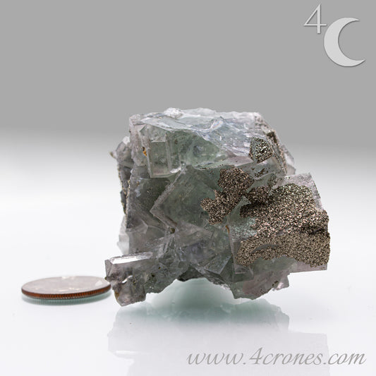 Fluorite & Pyrite beautiful lavender and soft green. This unique specimen of fluorite shimmers in soft bands of lavender and green, a natural harmony of color and energy. Composed of calcium fluoride, fluorite is valued for its cubic crystal formation and its ability to bring mental clarity and energetic alignment.