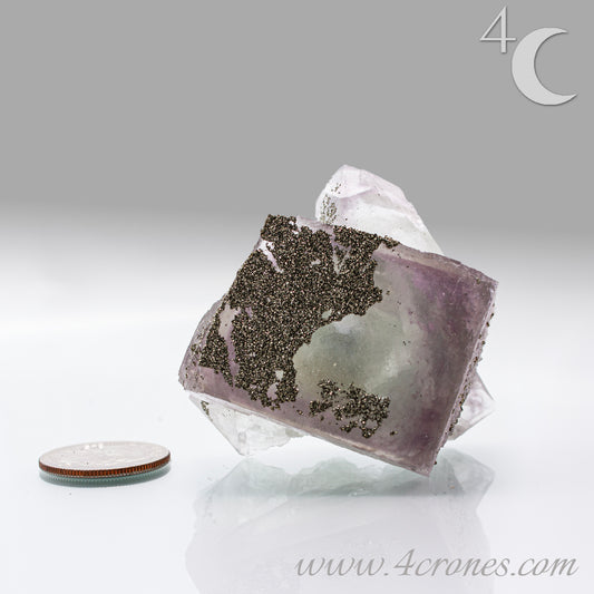 Fluorite & Pyrite beautiful lavender and soft green. This unique specimen of fluorite shimmers in soft bands of lavender and green, a natural harmony of color and energy. Composed of calcium fluoride, fluorite is valued for its cubic crystal formation and its ability to bring mental clarity and energetic alignment.