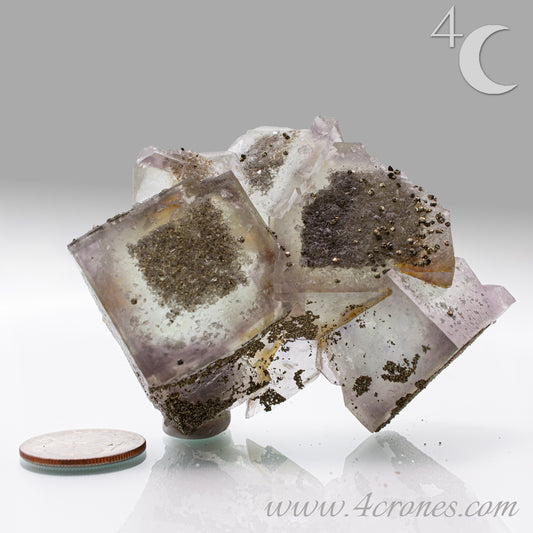 Fluorite & Pyrite beautiful lavender and soft green. This unique specimen of fluorite shimmers in soft bands of lavender and green, a natural harmony of color and energy. Composed of calcium fluoride, fluorite is valued for its cubic crystal formation and its ability to bring mental clarity and energetic alignment.