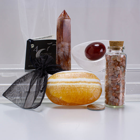 Collection of crystals and stones on a white surface with a neutral background