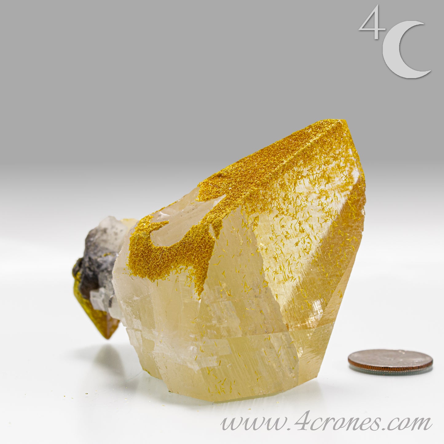 Mineral specimen with gold inclusions on a gray background, featuring the brand '4 Crones'.