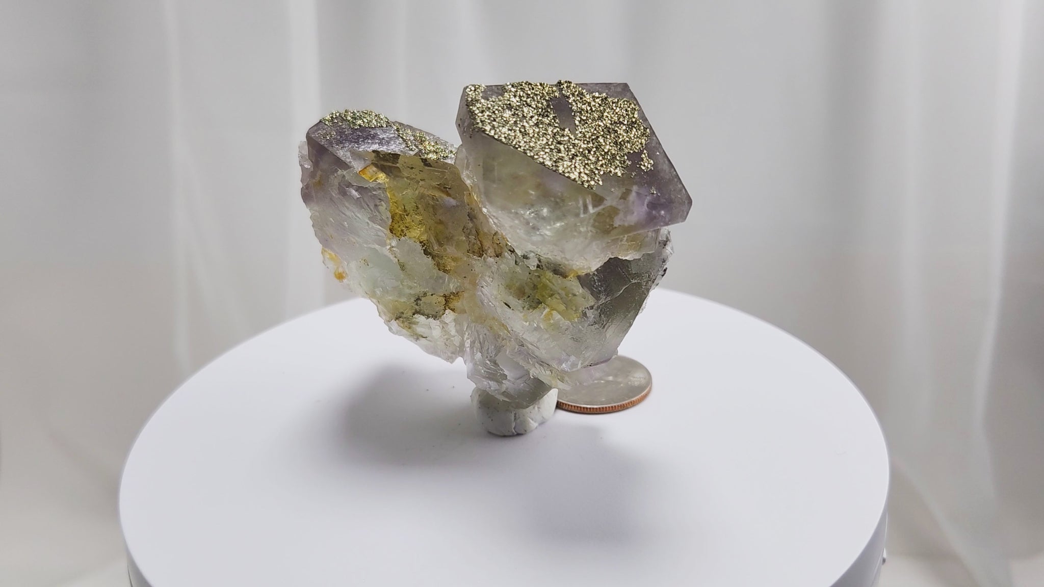 Fluorite & Pyrite beautiful lavender and soft green. This unique specimen of fluorite shimmers in soft bands of lavender and green, a natural harmony of color and energy. Composed of calcium fluoride, fluorite is valued for its cubic crystal formation and its ability to bring mental clarity and energetic alignment.