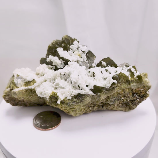 This unique pairing of Siderite, an iron carbonate mineral, and Dolomite, a calcium magnesium carbonate, forms in earthy clusters and blocky crystals that range from honeyed brown to soft cream.