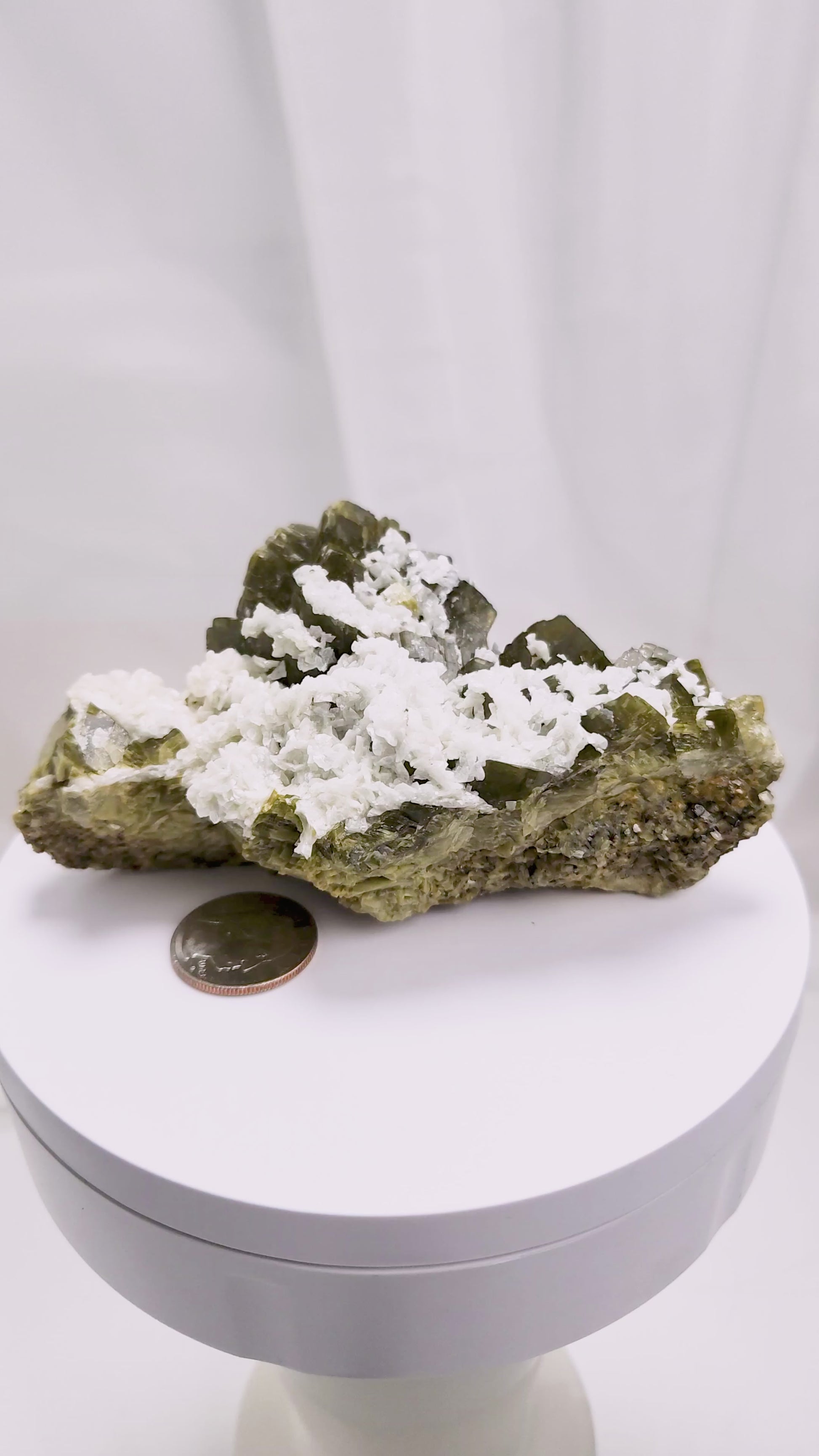 This unique pairing of Siderite, an iron carbonate mineral, and Dolomite, a calcium magnesium carbonate, forms in earthy clusters and blocky crystals that range from honeyed brown to soft cream.