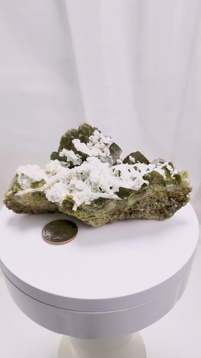 This unique pairing of Siderite, an iron carbonate mineral, and Dolomite, a calcium magnesium carbonate, forms in earthy clusters and blocky crystals that range from honeyed brown to soft cream.