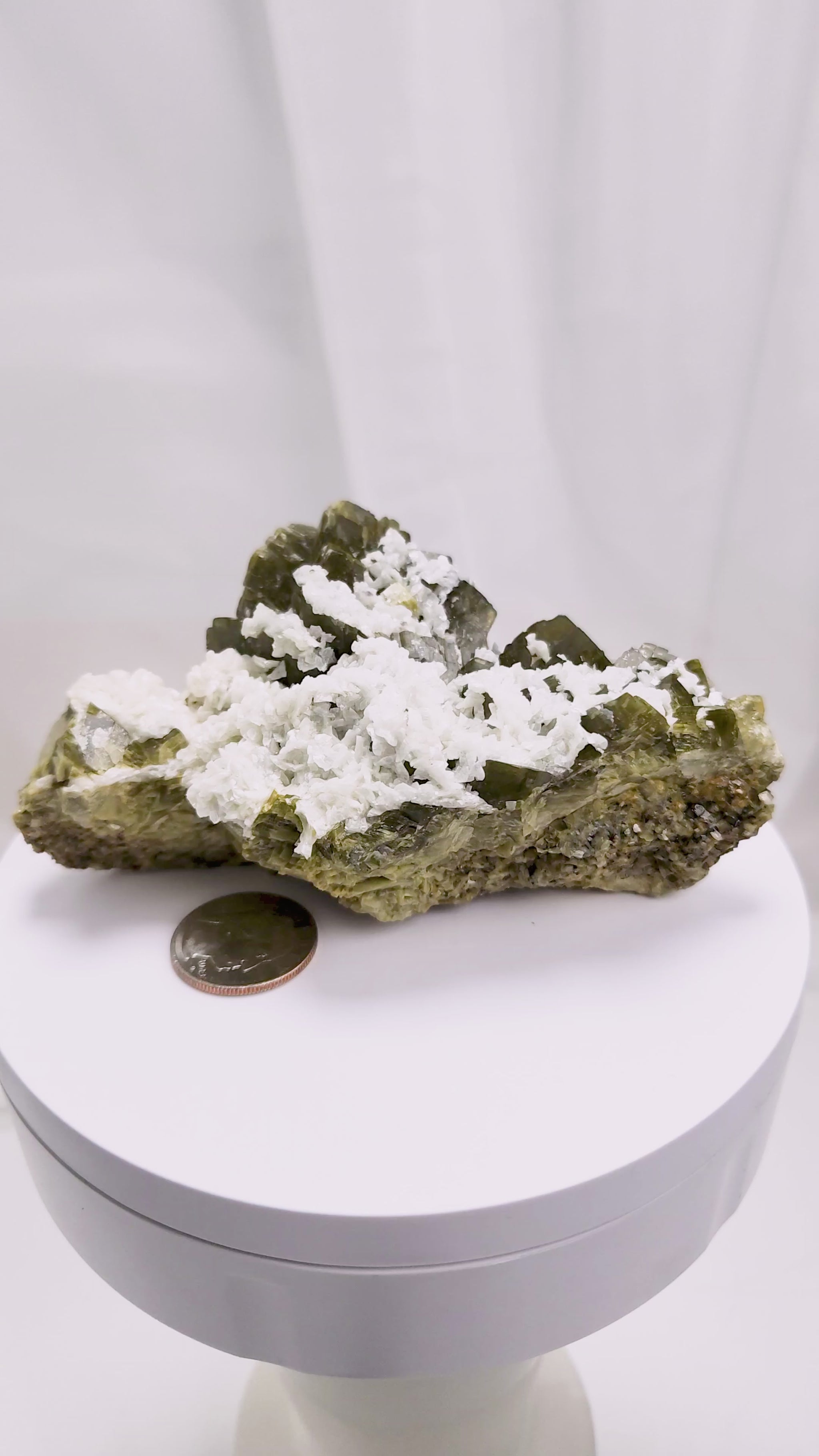 This unique pairing of Siderite, an iron carbonate mineral, and Dolomite, a calcium magnesium carbonate, forms in earthy clusters and blocky crystals that range from honeyed brown to soft cream.