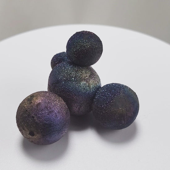 These stunning Chalcopyrite copper iron sulfide spheres (CuFeS₂) showcase a metallic golden luster with vibrant iridescent hues of purple, blue, and green. Formed through hydrothermal processes in Daye, Hubei Province, they crystallize in the tetragonal system and are valued for their aesthetic and energetic properties.