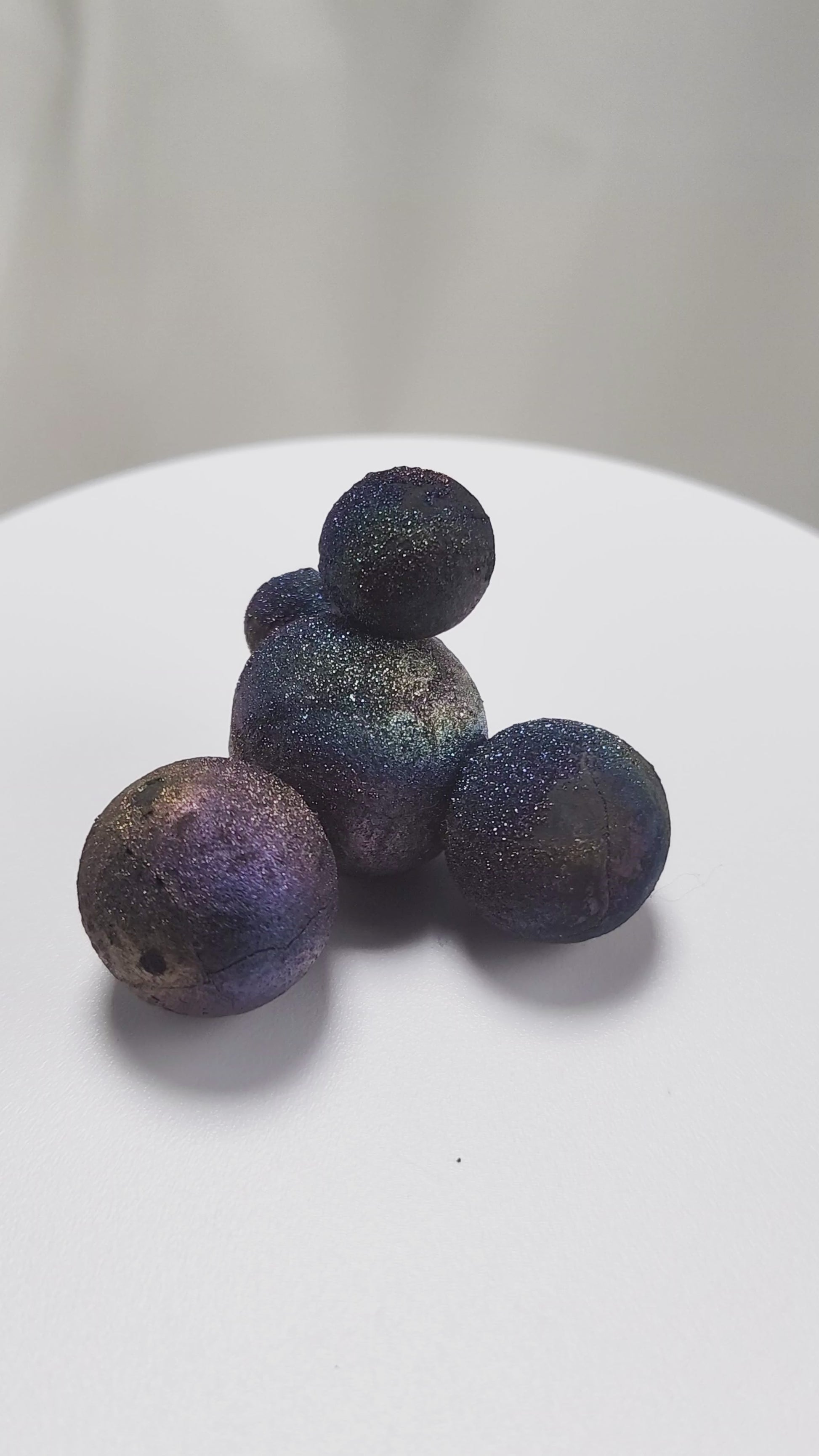 These stunning Chalcopyrite copper iron sulfide spheres (CuFeS₂) showcase a metallic golden luster with vibrant iridescent hues of purple, blue, and green. Formed through hydrothermal processes in Daye, Hubei Province, they crystallize in the tetragonal system and are valued for their aesthetic and energetic properties.