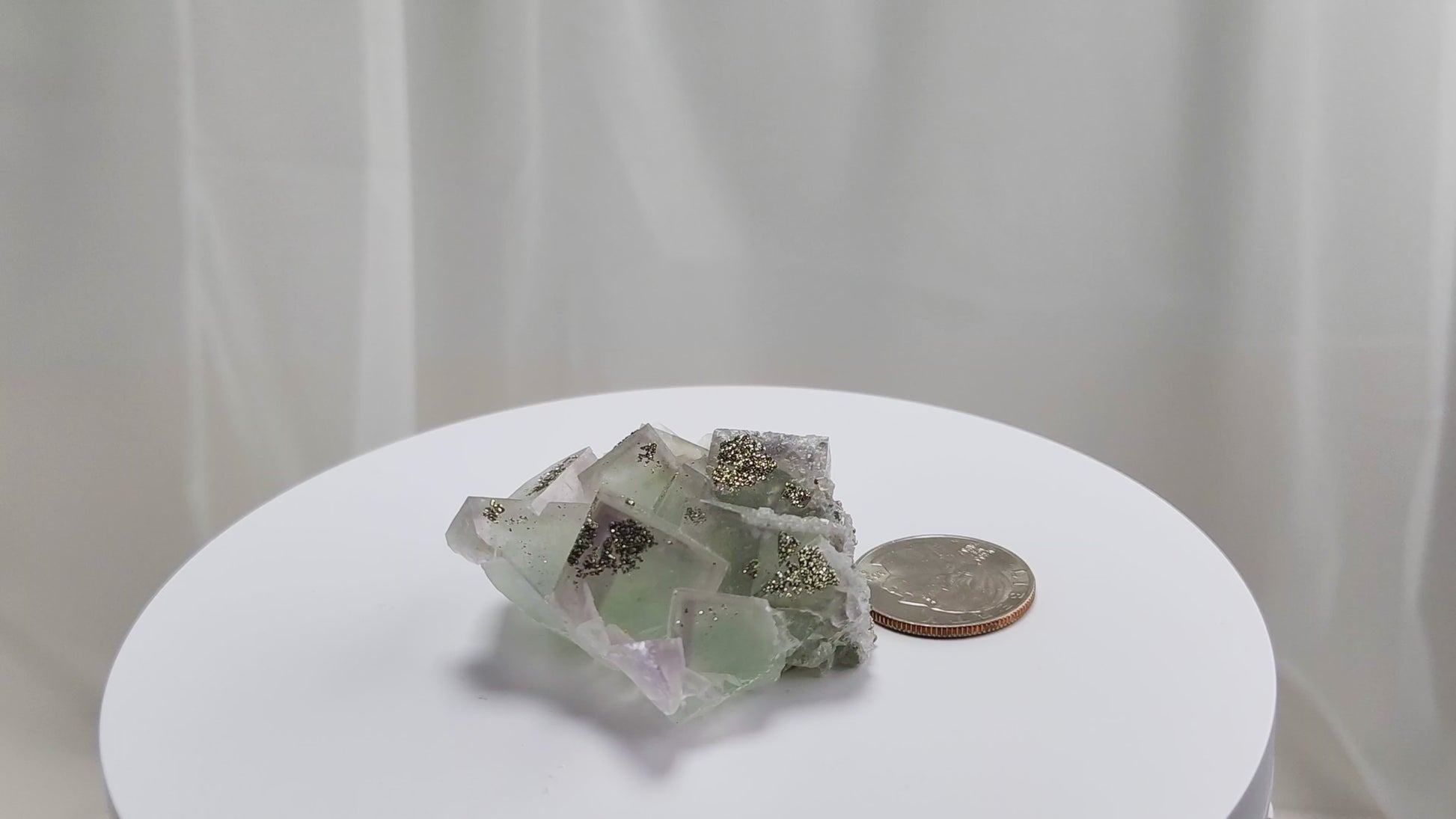Fluorite & Pyrite beautiful lavender and soft green. This unique specimen of fluorite shimmers in soft bands of lavender and green, a natural harmony of color and energy. Composed of calcium fluoride, fluorite is valued for its cubic crystal formation and its ability to bring mental clarity and energetic alignment.