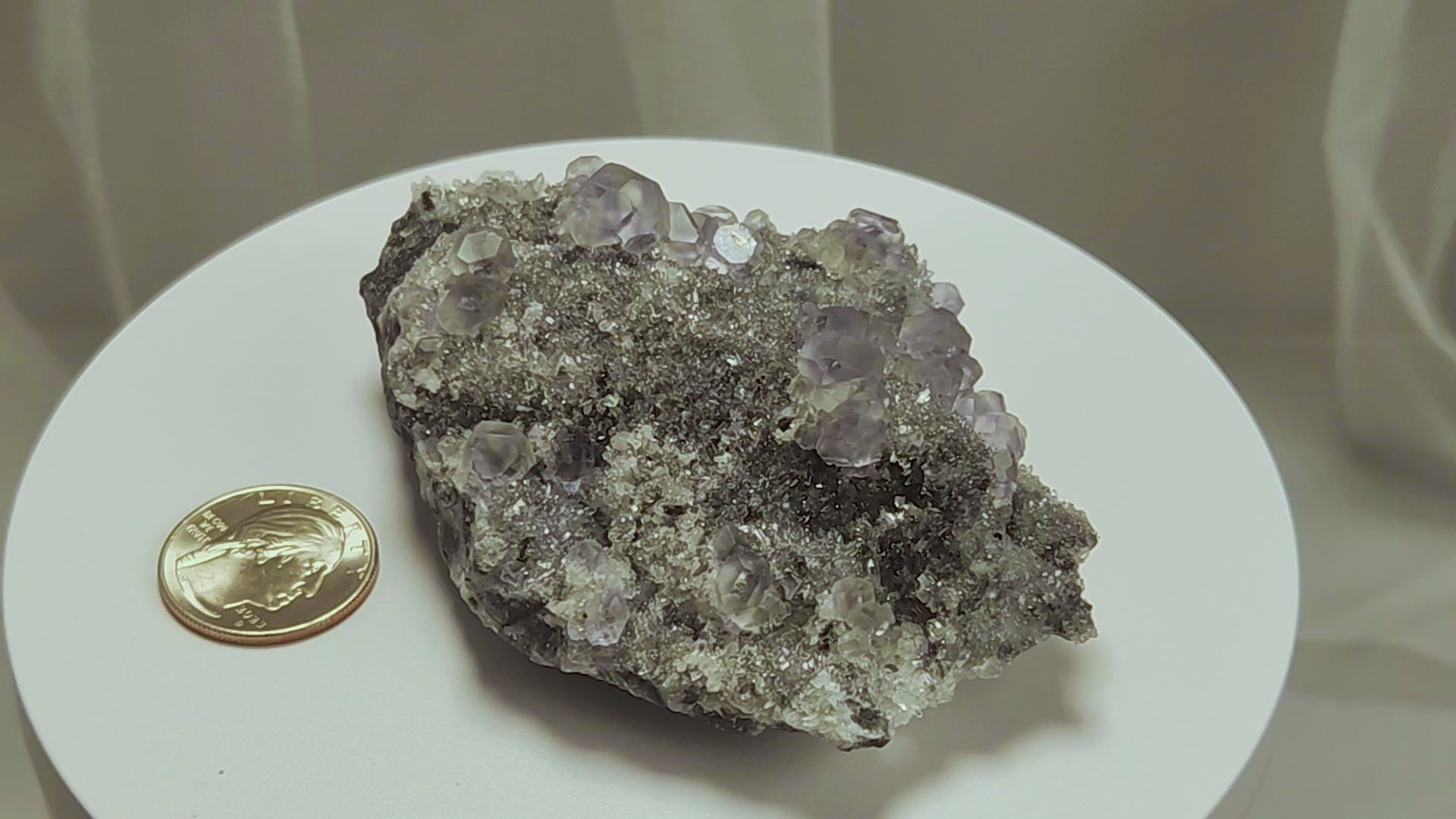 These beautiful green fluorites have enchanting delicate blue-purple phantoms. They are nestled in a dazzling bed of sparkling needle quartz and their subtlety and color shifts under various light sources create the feeling of being on a treasure hunt. Suddenly, another purple-blue phantom fluorite crystal appears amidst the crystal-clear twinkling needle quartz points. To top it off these amazing specimens glow and fluoresce a deep Lavendar under UV light. www.4crones.com