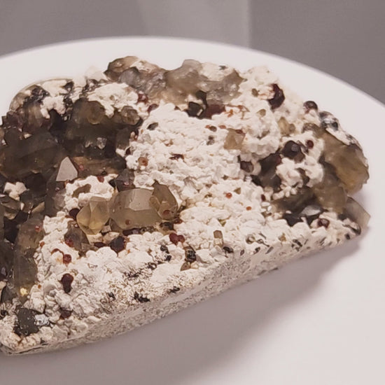 These gemmy Garnets are known as Spessartine Red Garnets, and they encrust and surround beautiful Smoky Quartz crystals on microcline feldspar matrices.  The mine these specimens come from is known for the beautiful blingy red- and orange-colored garnets that they yield. www.4crones.com