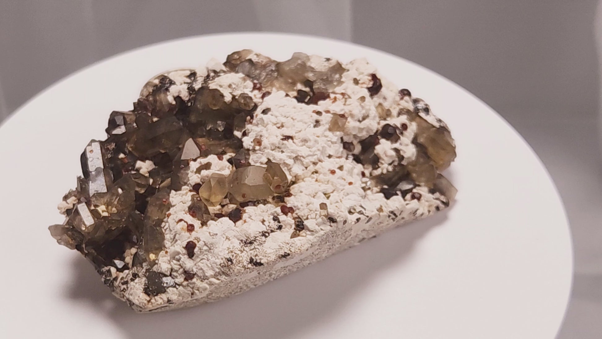 These gemmy Garnets are known as Spessartine Red Garnets, and they encrust and surround beautiful Smoky Quartz crystals on microcline feldspar matrices.  The mine these specimens come from is known for the beautiful blingy red- and orange-colored garnets that they yield. www.4crones.com