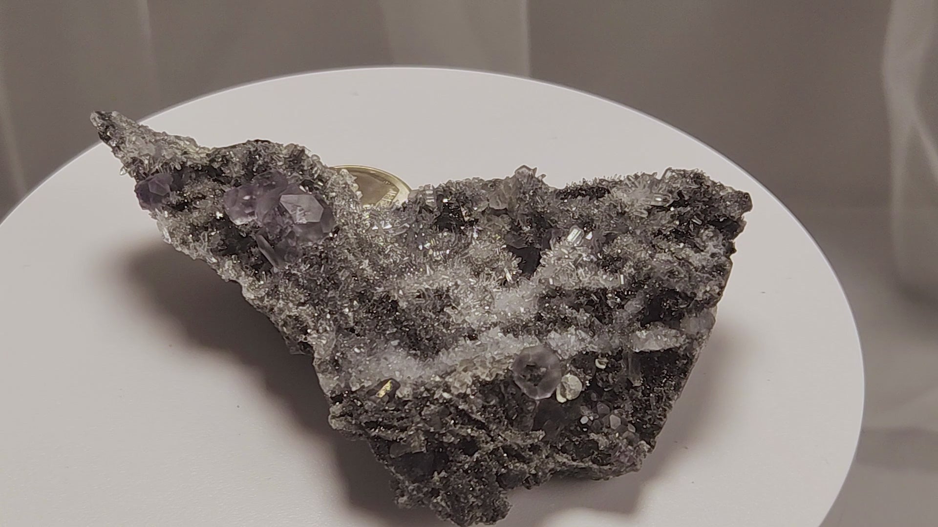 These beautiful green fluorites have enchanting delicate blue-purple phantoms. They are nestled in a dazzling bed of sparkling needle quartz and their subtlety and color shifts under various light sources create the feeling of being on a treasure hunt. Suddenly, another purple-blue phantom fluorite crystal appears amidst the crystal-clear twinkling needle quartz points. To top it off these amazing specimens glow and fluoresce a deep Lavendar under UV light. www.4crones.com