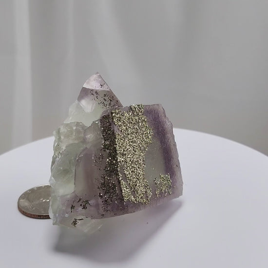 Fluorite & Pyrite beautiful lavender and soft green. This unique specimen of fluorite shimmers in soft bands of lavender and green, a natural harmony of color and energy. Composed of calcium fluoride, fluorite is valued for its cubic crystal formation and its ability to bring mental clarity and energetic alignment.